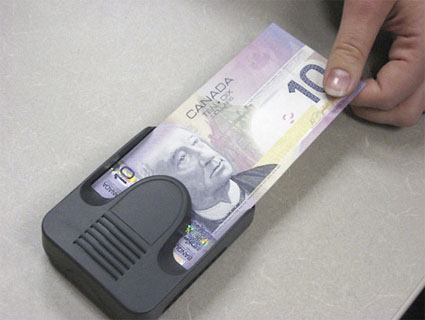 Canadian bills are compatible with a hand-held electronic bank note reader, provided free by the Bank of Canada through the Canadian National Institute for the Blind. The reader can announce the denomination, beep or vibrate a code representing the denomination. Courtesy of Bank of Canada.